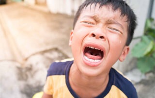 Parent comforting a child with autism during a meltdown