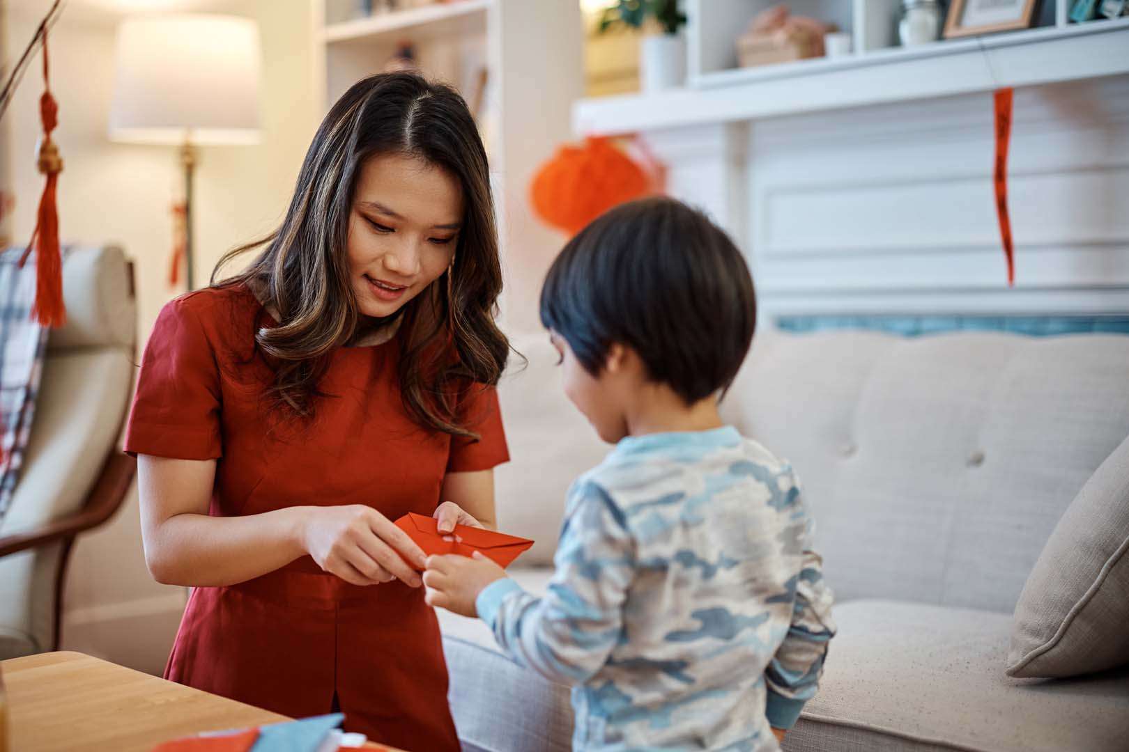 A mother and child share a moment during a festive activity, illustrating the importance of daily interactions in speech development.