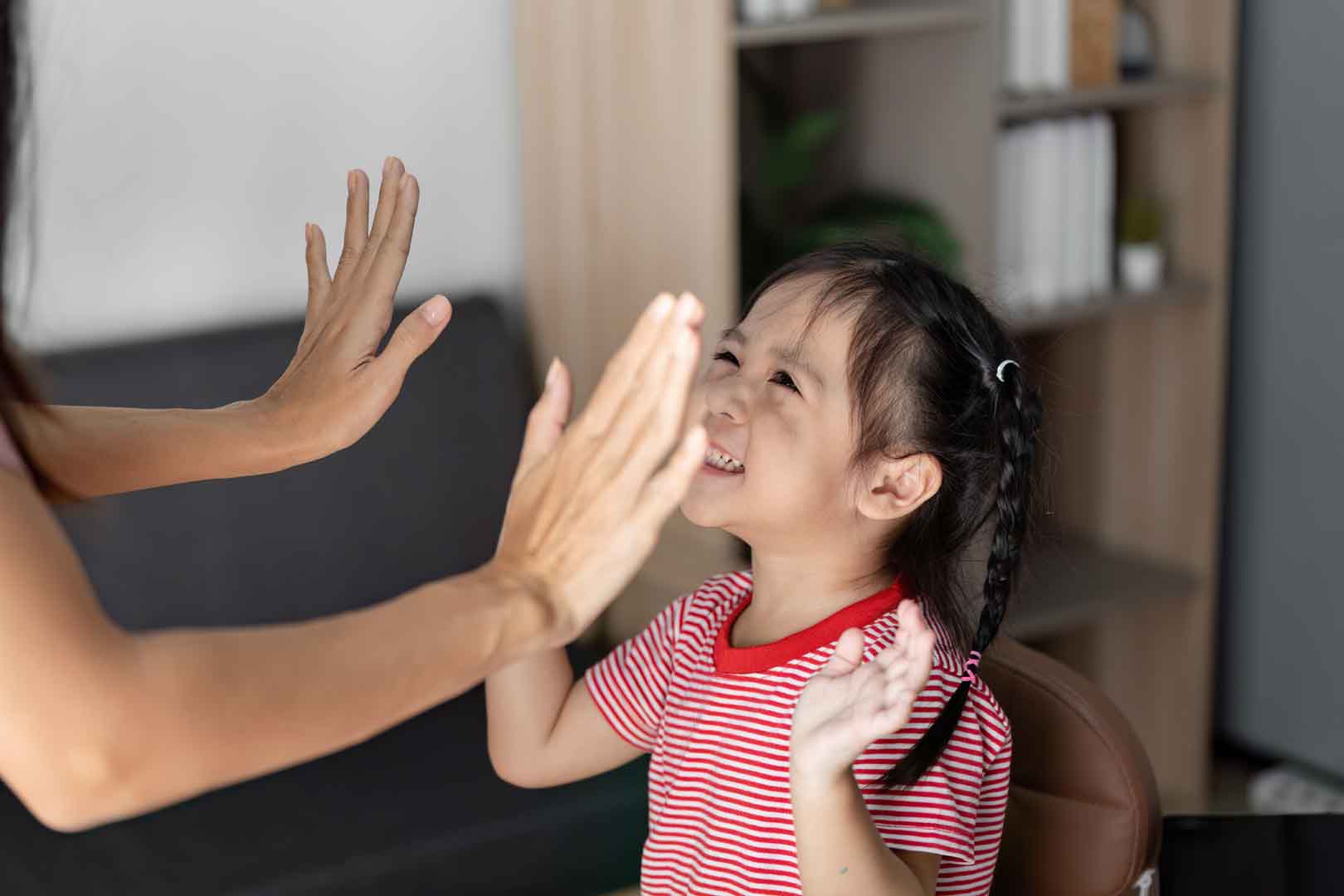 A preschool-aged child receiving one-on-one support from a therapist at OrbRom Center in Phnom Penh