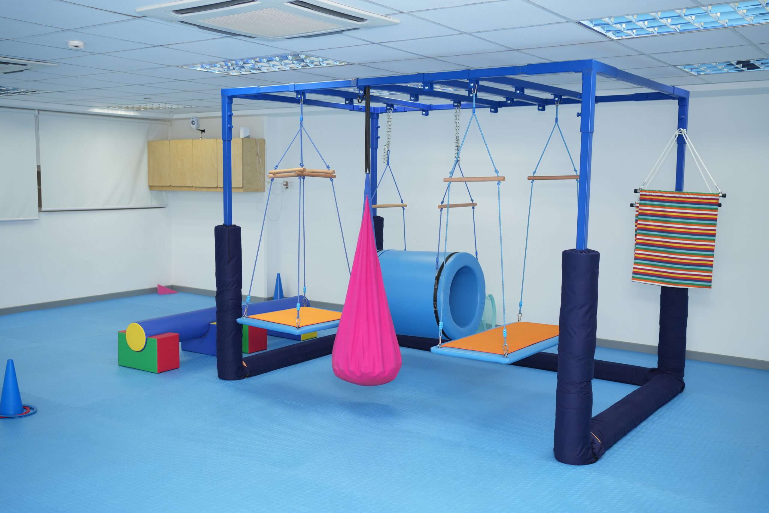 Sensory room setup at OrbRom Center in Phnom Penh featuring swings, soft play equipment, and calming tools for occupational therapy