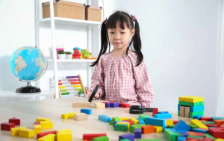 Young girl engaging in colorful early learning activities at a preschool program designed to develop bright minds in Phnom Penh