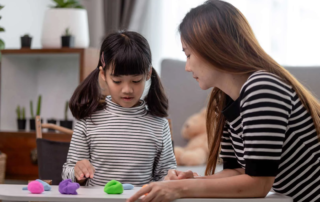 Therapist working with a child using play-based activities in a Phnom Penh school focused on growing minds