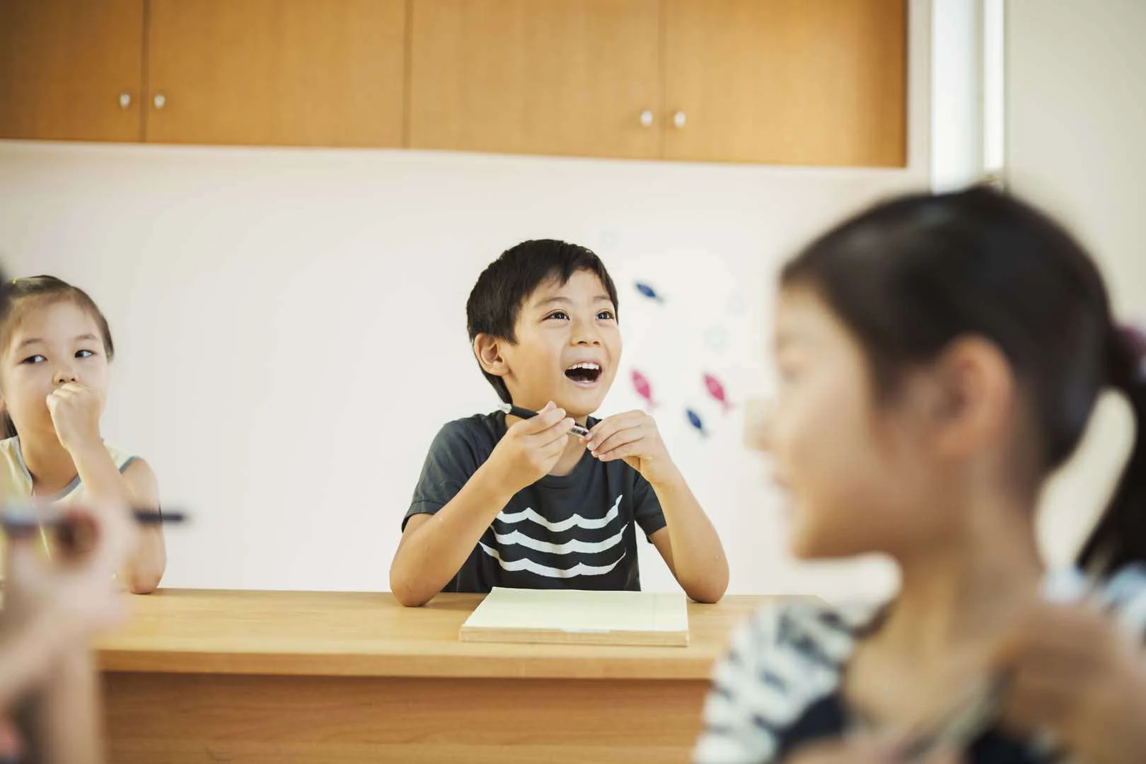 Group of children participating in a speech therapy session, smiling and practicing communication skills in Phnom Penh