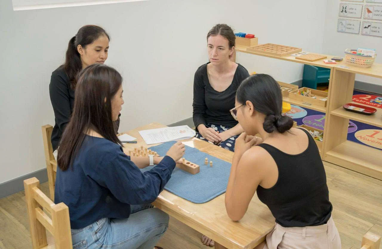 Educators and therapists collaborating at OrbRom Center in Phnom Penh to enhance special education services for children with diverse needs.