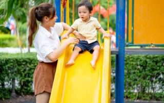 A young child at OrbRom Center participating in a group activity designed to build self-confidence through play and interaction in Phnom Penh.