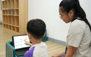 Autism therapist at OrbRom Center working individually with a child in a calm and structured setting in Phnom Penh