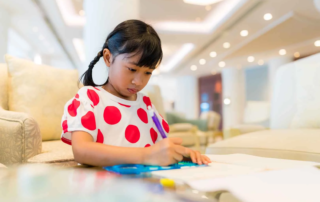 Child at OrbRom Center communicating comfortably without making direct eye contact during an autism therapy session.