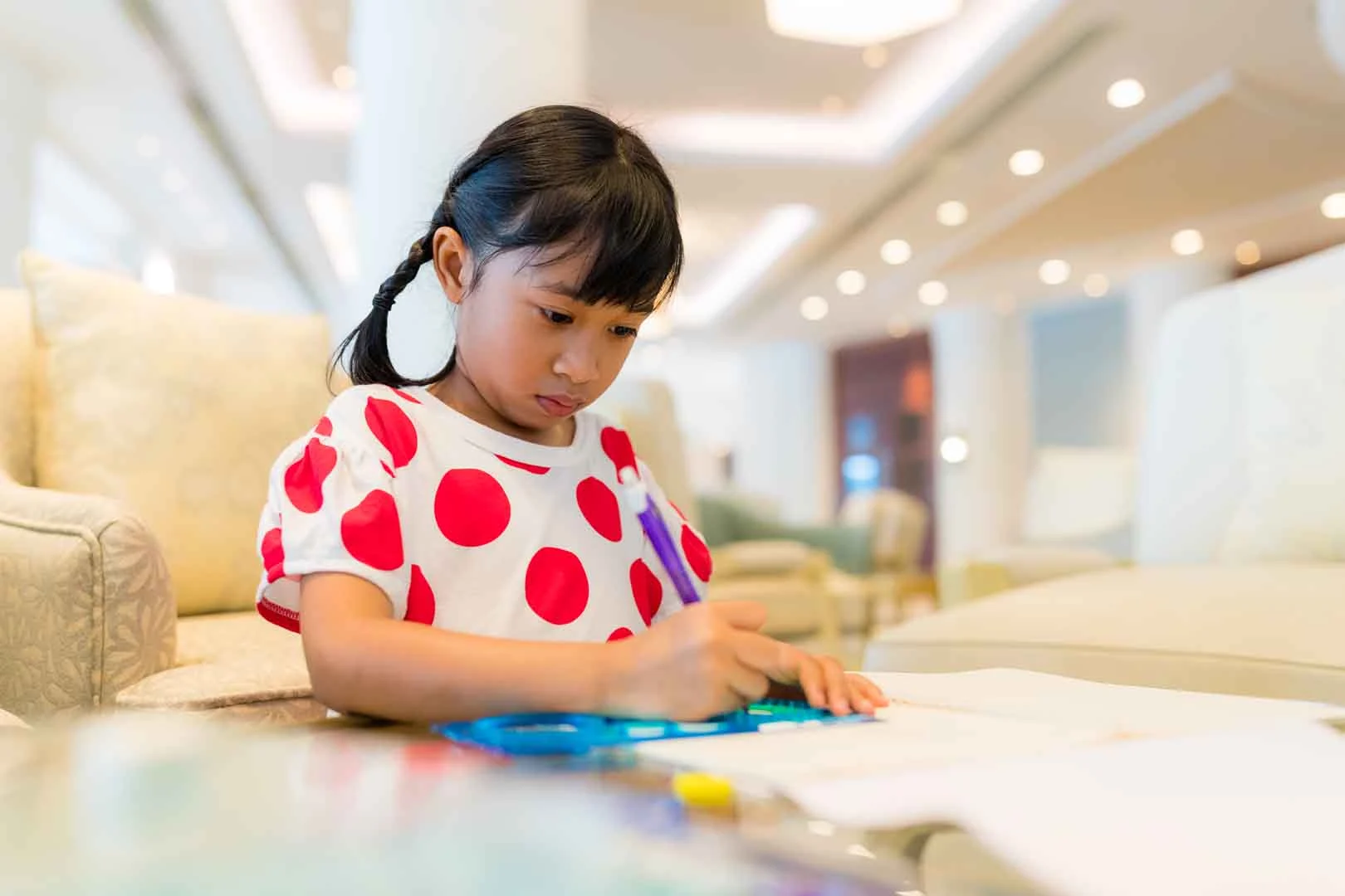 Child at OrbRom Center communicating comfortably without making direct eye contact during an autism therapy session.