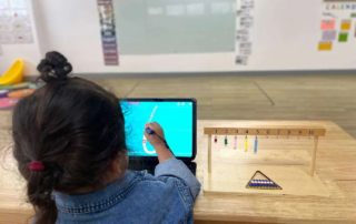 oung child using digital tracing app and counting beads at OrbRom Center’s early learning classroom in Phnom Penh