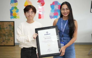 High school volunteer Ear Kimse receiving certificate at OrbRom Center