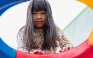 Child in Phnom Penh developing fine motor skills with occupational therapist