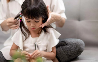 Speech therapist at OrbRom Center working with a young child during an early intervention session in Phnom Penh
