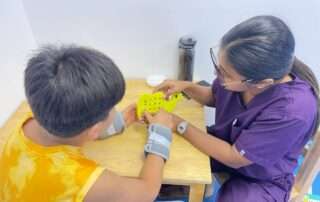One-on-one occupational therapy session at OrbRom Center in Phnom Penh using visual and motor skill tools