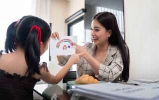 Child participating in a speech therapy session at OrbRom Center in Phnom Penh, engaging in communication-building activities.