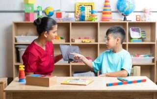Child engaged in high-repetition, motor-based speech therapy for Childhood Apraxia of Speech at OrbRom Center, Phnom Penh