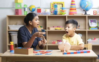 A therapist guides a young child through mouth movement exercises to improve speech clarity at OrbRom Center.