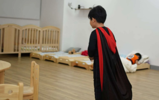 Children participating in a structured Halloween-themed preschool morning with decorated learning areas at OrbRom Center.