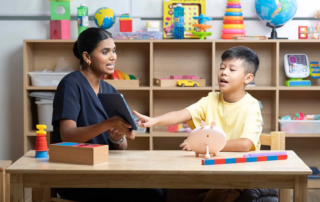 Child using AAC supports during therapy at OrbRom Center in Phnom Penh to build everyday communication