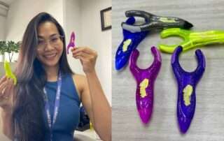 Teacher demonstrating an adaptive pencil with a child-friendly grip to support handwriting at OrbRom Center