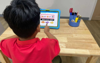 Child completing an on-screen “What comes next?” pattern activity during a learning session.
