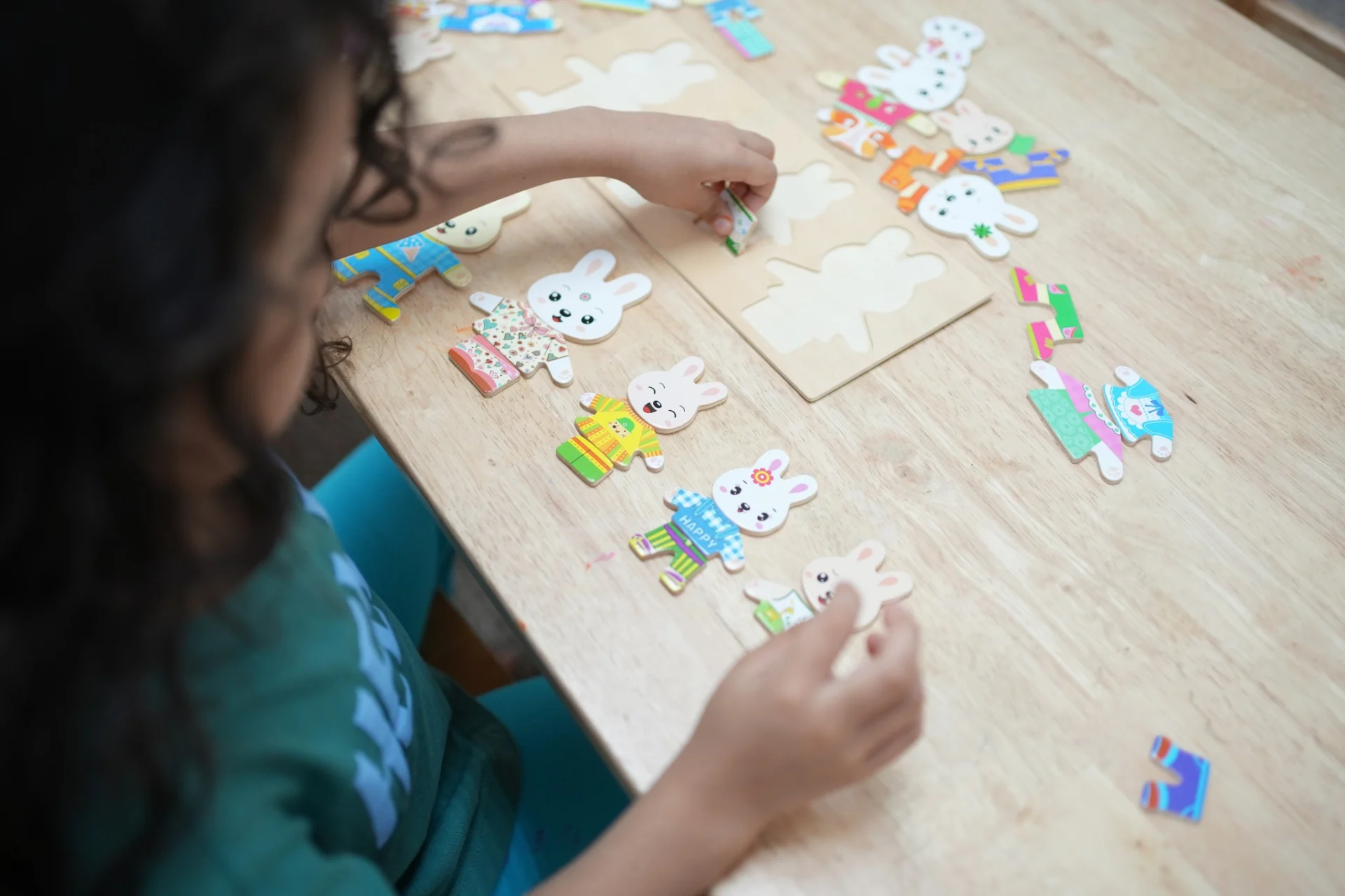 Child practicing structured play and problem-solving skills using educational puzzles during an autism-focused learning activity at OrbRom Center