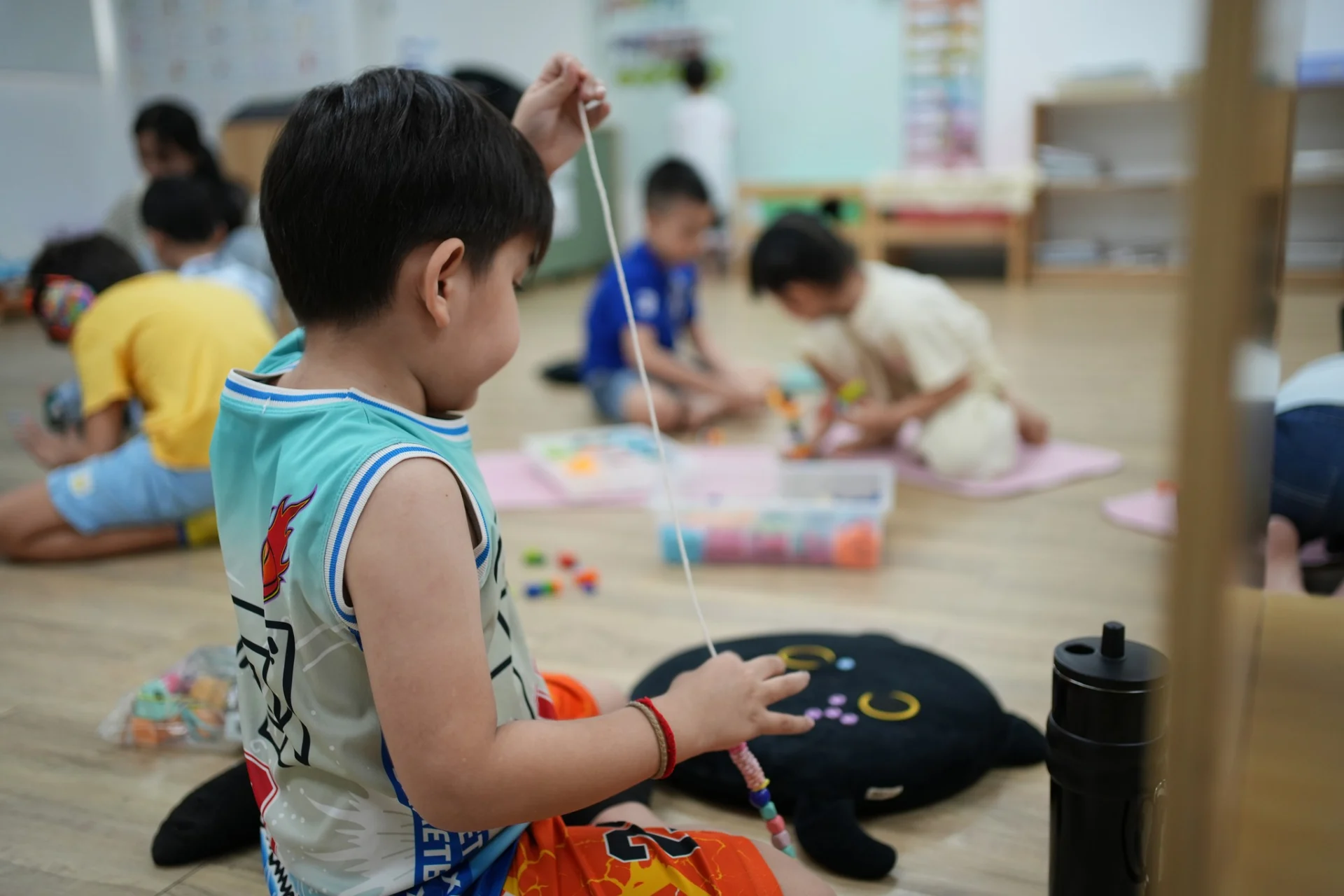 Child practicing fine-motor and focus skills during a structured preschool activity at OrbRom Center