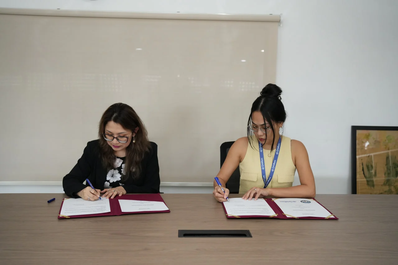 Representatives from Vision Bridge International Academy and OrbRom Center signing an MoU to support inclusive education initiatives in Phnom Penh.