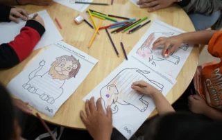 Children working on coloring and drawing tasks to improve fine motor and attention skills