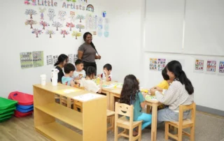 Children participating in structured group activity in a preschool classroom with teacher guidance
