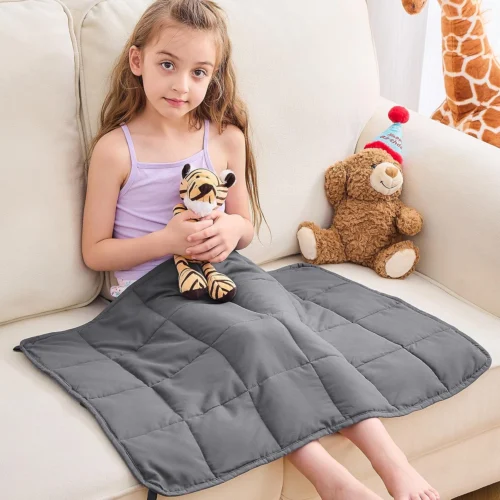 Child using a weighted lap blanket for sensory regulation and calming support