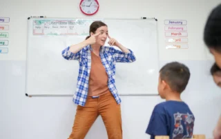 Kate, Lead Teacher at OrbRom Learning Support Center, uses expressive gestures and animated teaching to engage students during an interactive classroom lesson.