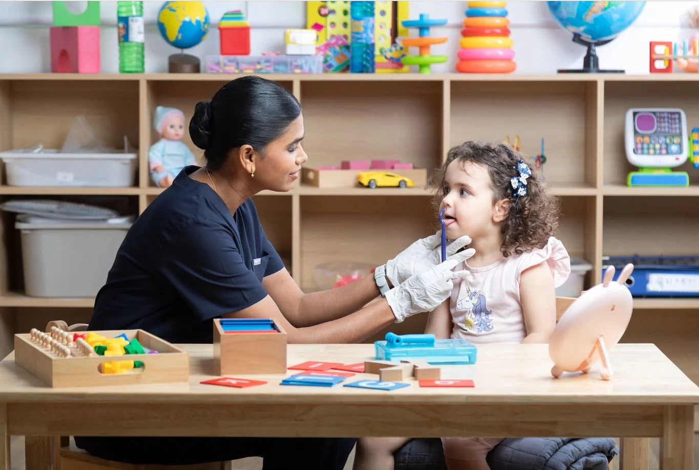 Speech therapist working with a child during an individual session at OrbRom Center in Phnom Penh.